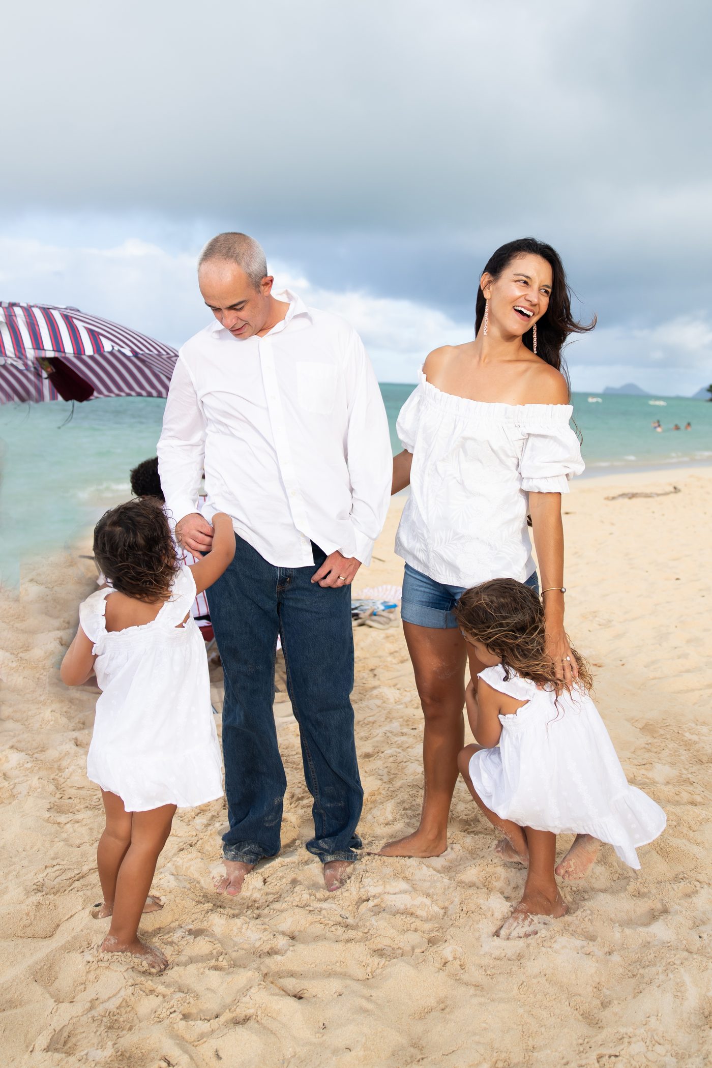 Katie Nickens with her husband and daughters on a Windward Oʻahu beach